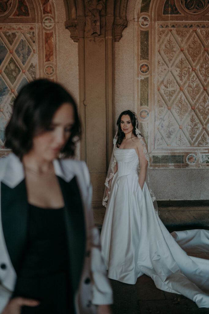 Artistic portrait of two brides during intimate Central Park NYC elopement ceremony at Bethesda Terrace