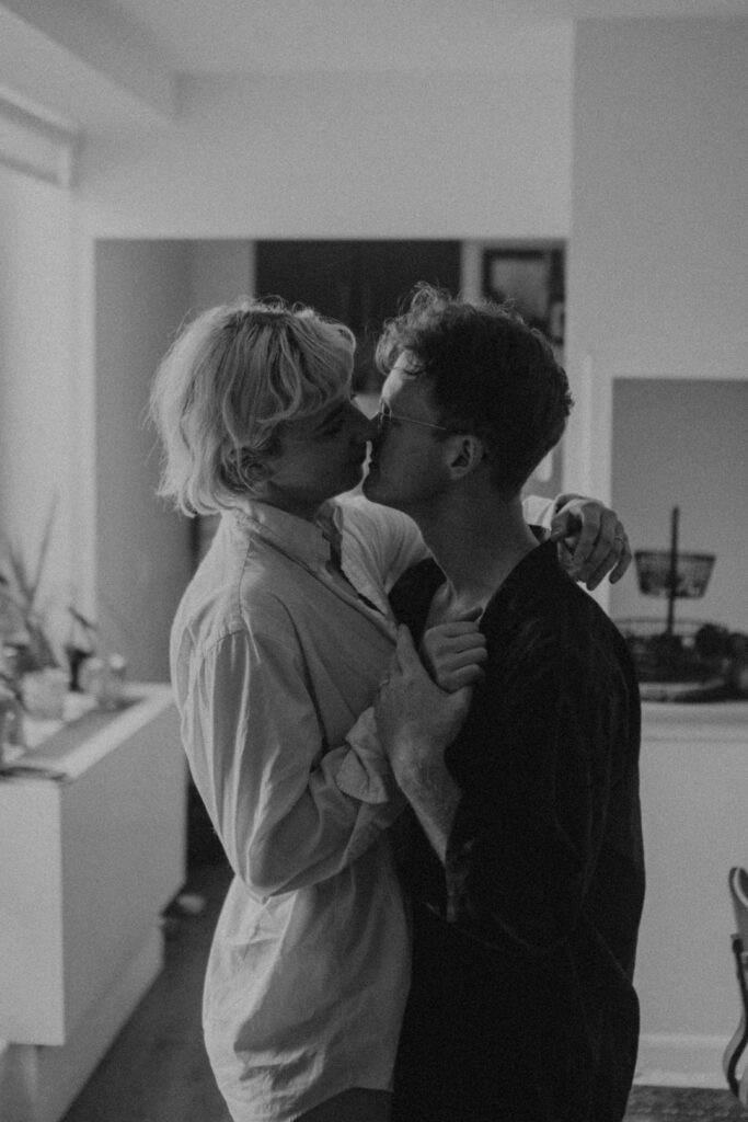 Black and white photo of couple dancing together in living room during unposed intimate couple session NYC