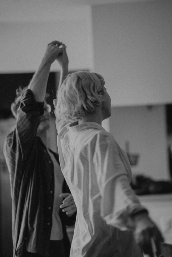 Black and white candid photo of couple dancing in living room intimate couple photography New York City