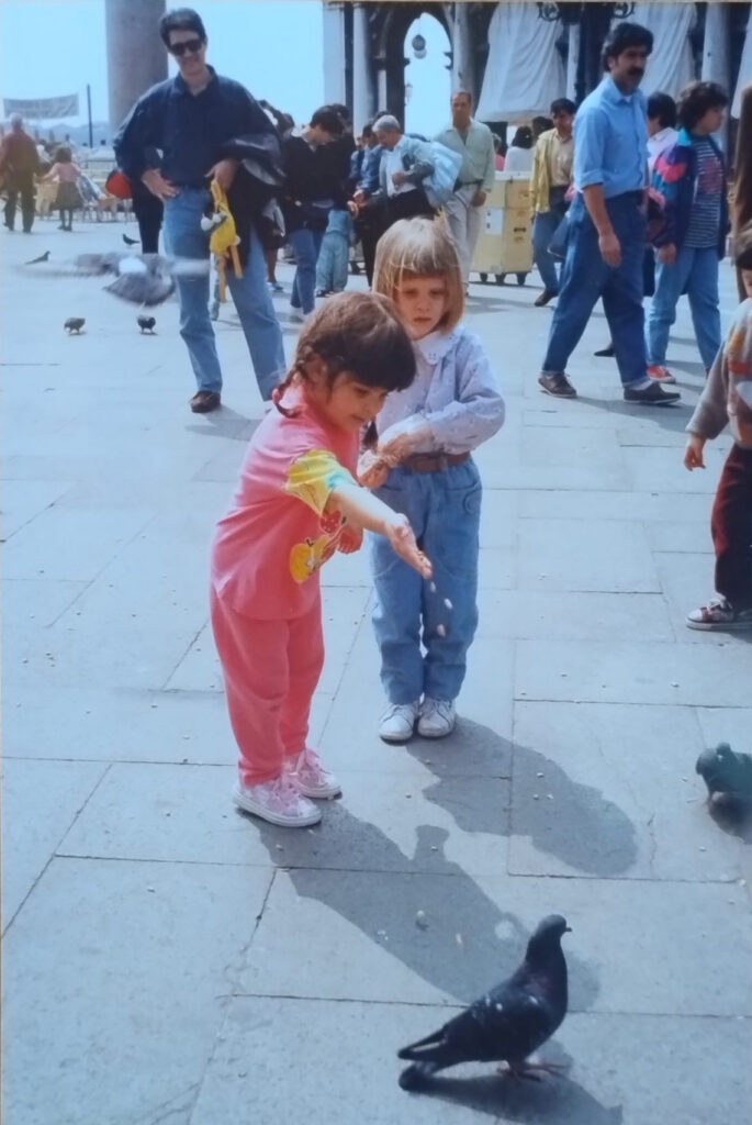 Valentina as a child feeding pigeons in Piazza San Marco, Venice.